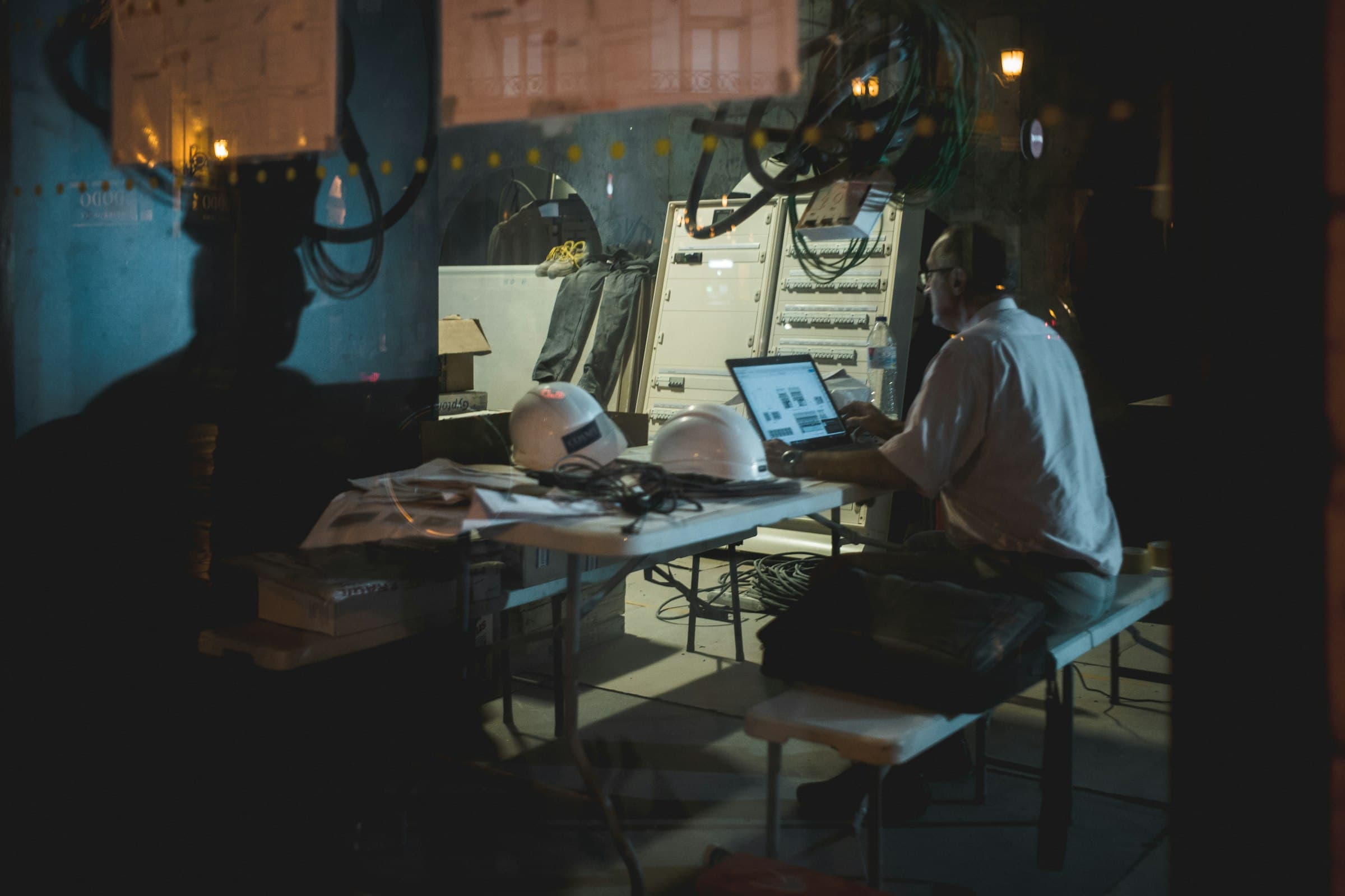 An owner working at a laptop in his shop after hours